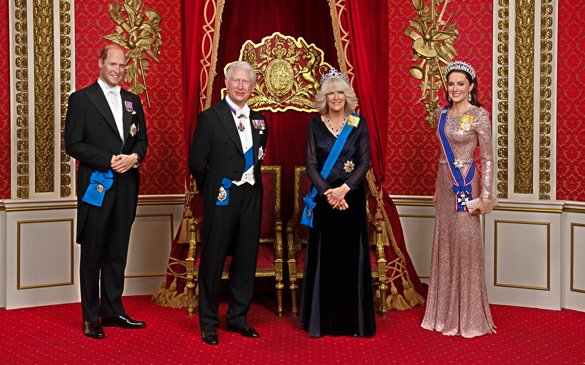 Wax figures of British royals in regal attire at Madame Tussauds London.