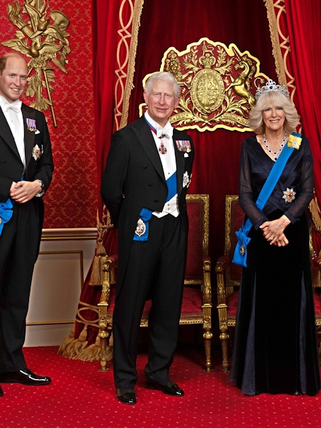 Wax figures of British royals in regal attire at Madame Tussauds London.