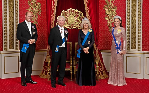 Wax figures of British royals in regal attire at Madame Tussauds London.