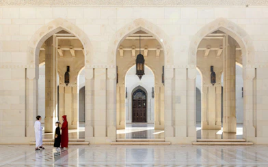 Guide interacting with tourists in the courtyard of the Royal Opera House, Muscat.