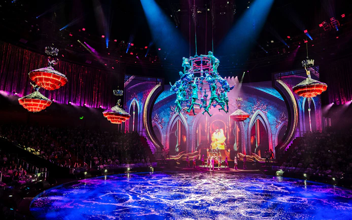 Acrobats performing above water stage during House of Dancing Water show.