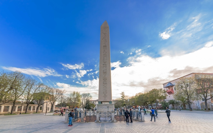 Hippodrome Obelisk in Istanbul, Turkey with visitors exploring the historic site.