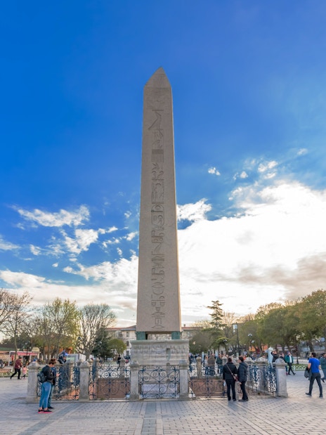 Hippodrome Obelisk in Istanbul, Turkey with visitors exploring the historic site.