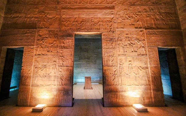 Philae Temple interior with illuminated hieroglyphics during light show, Egypt.