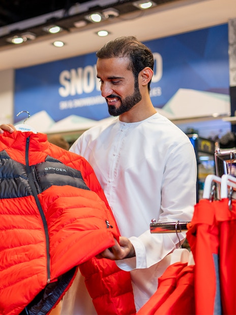People selecting ski jackets at Ski Dubai Snow Park.