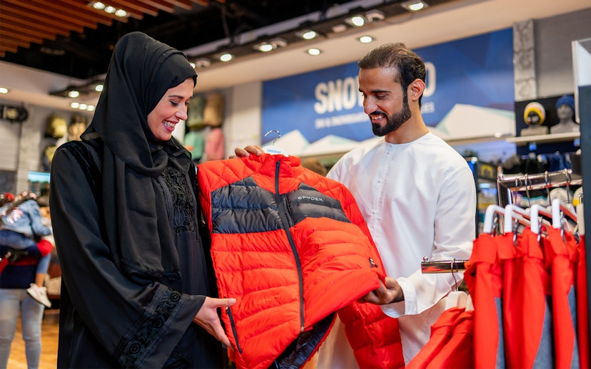 People selecting ski jackets at Ski Dubai Snow Park.