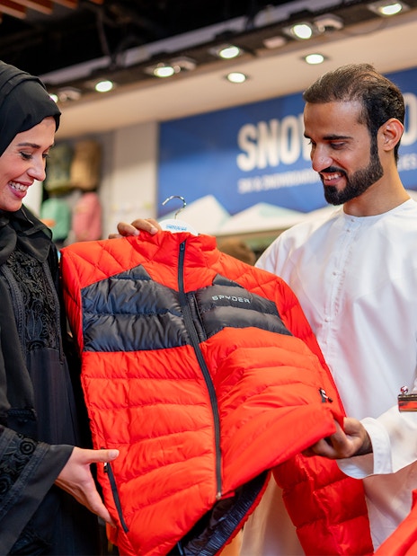 People selecting ski jackets at Ski Dubai Snow Park.