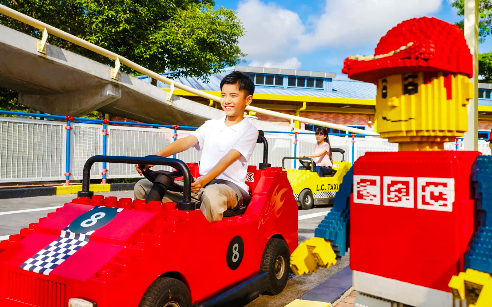 Children driving Lego cars at Legoland Theme Park Malaysia driving school.