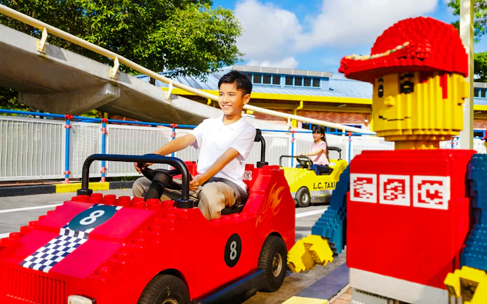 Children driving Lego cars at Legoland Theme Park Malaysia driving school.