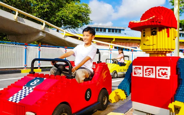Children driving Lego cars at Legoland Theme Park Malaysia driving school.