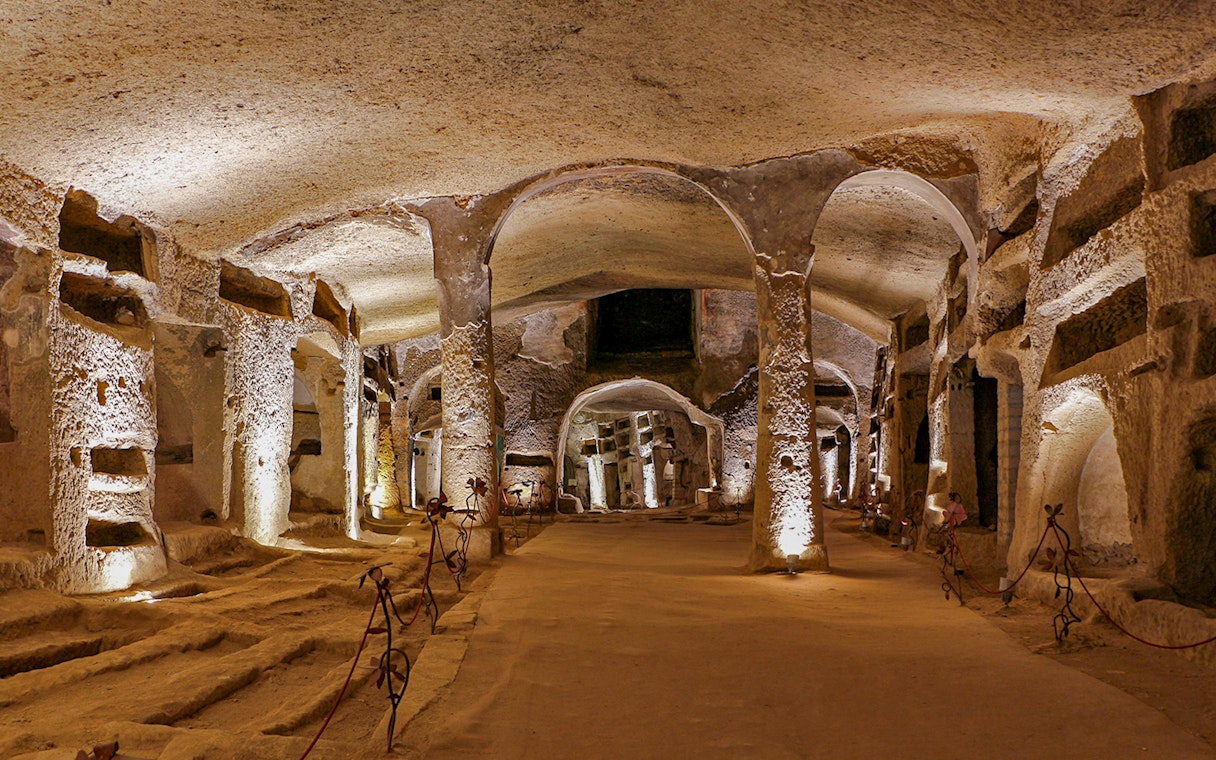 Catacombs of San Gennaro in Naples with ancient burial niches and arches.