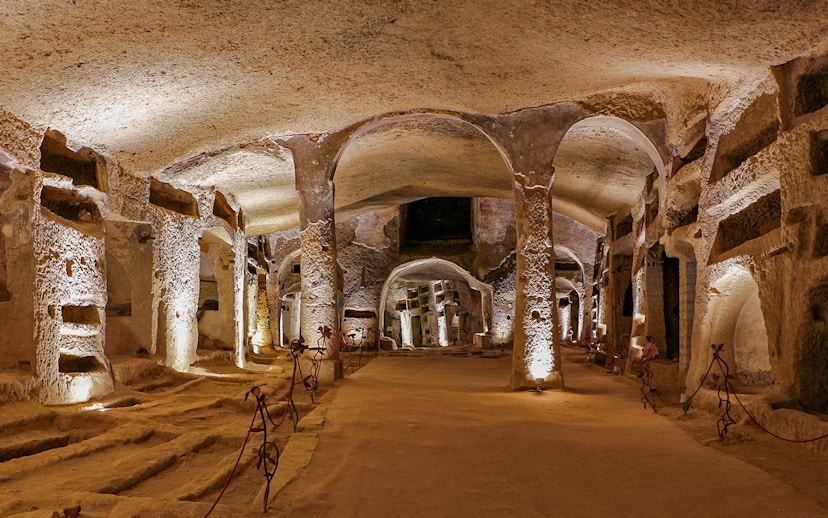 Catacombs of San Gennaro in Naples with ancient burial niches and arches.