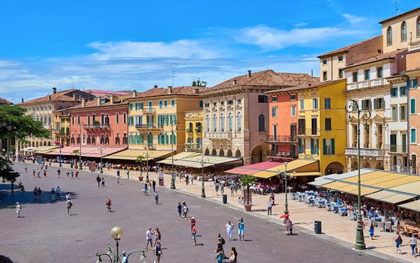 Piazza Bra Verona Italy cafes restaurants shops with Arena di Verona in background.
