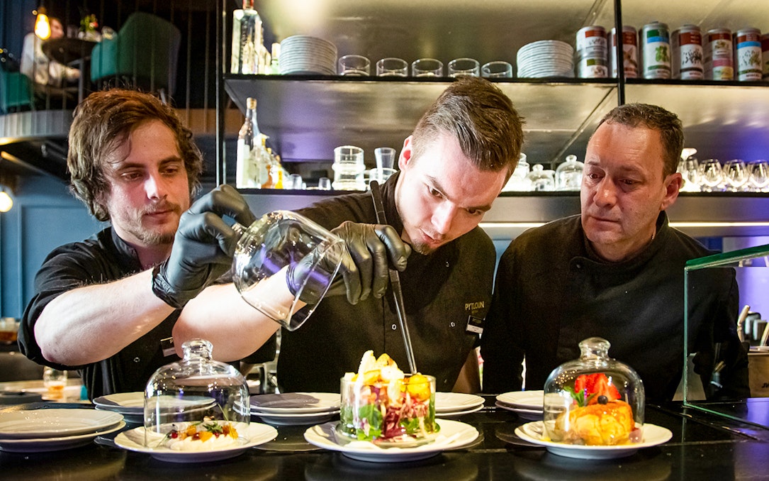 Chef preparing Czech tapas dishes during a cuisine tasting tour.