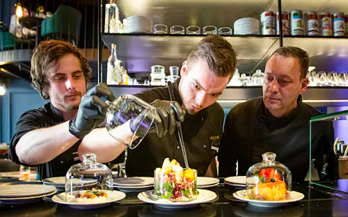 Chef preparing Czech tapas dishes during a cuisine tasting tour.