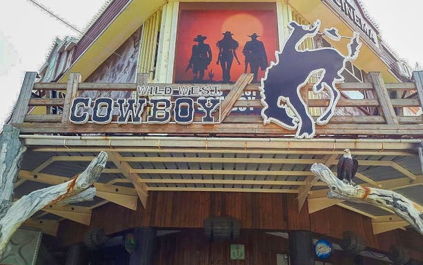 Wild West Cowboy entrance with cowboy silhouettes and horse sign.