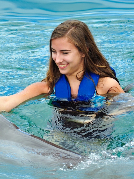 Girl interacting with dolphin at Pattaya Dolphinarium.