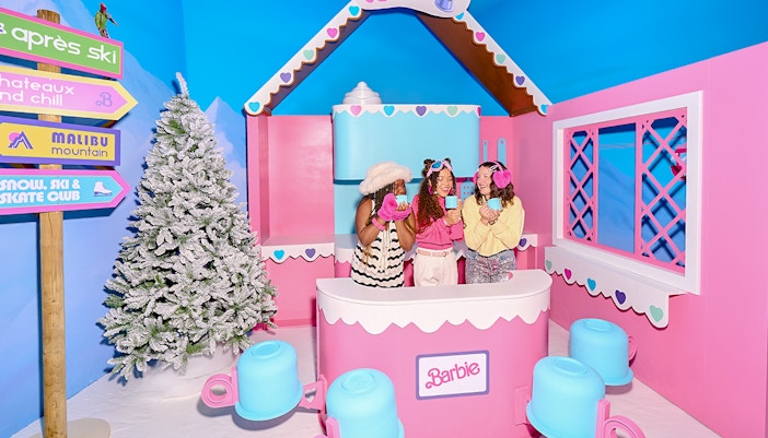 Guests enjoying Barbie The Dream Experience in Amsterdam with winter-themed decor.