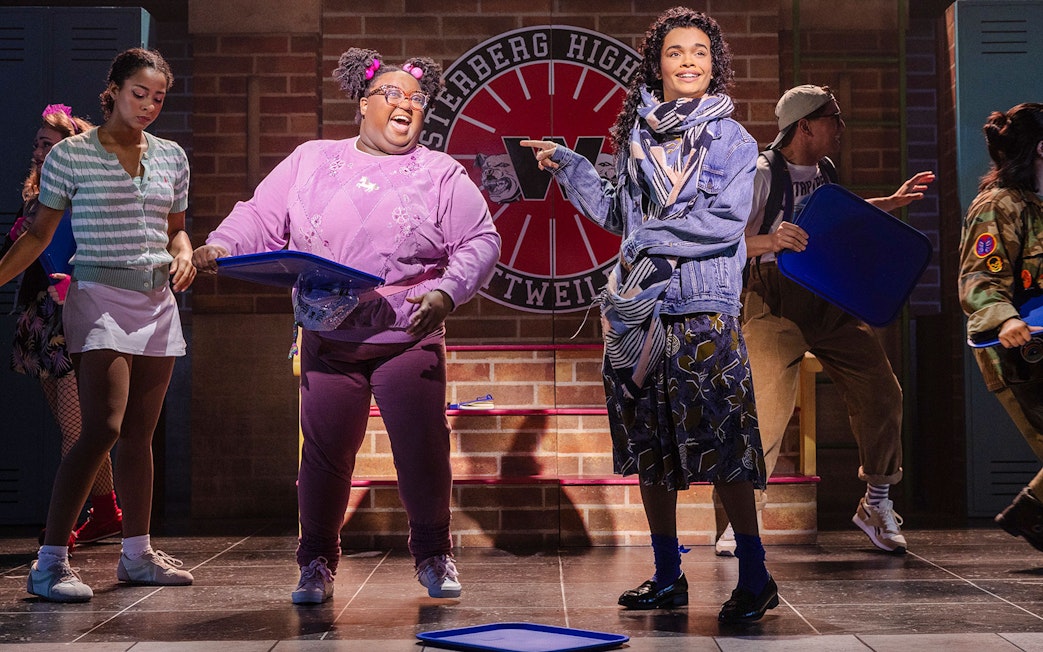 Cast performing a scene from Heathers: The Musical on stage at Westerberg High.
