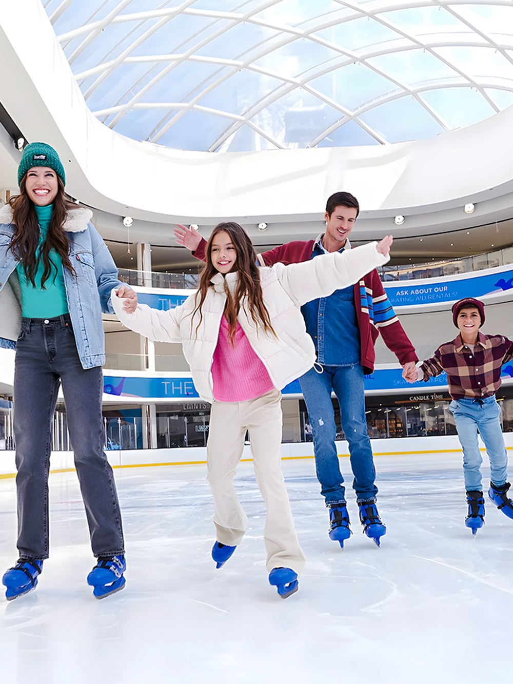 People ice skating at the American Dream ice rink under a glass dome.