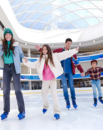 People ice skating at the American Dream ice rink under a glass dome.