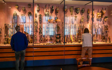 Visitors viewing African masks and artifacts at the Land Unknown exhibit, National Museum of Denmark.