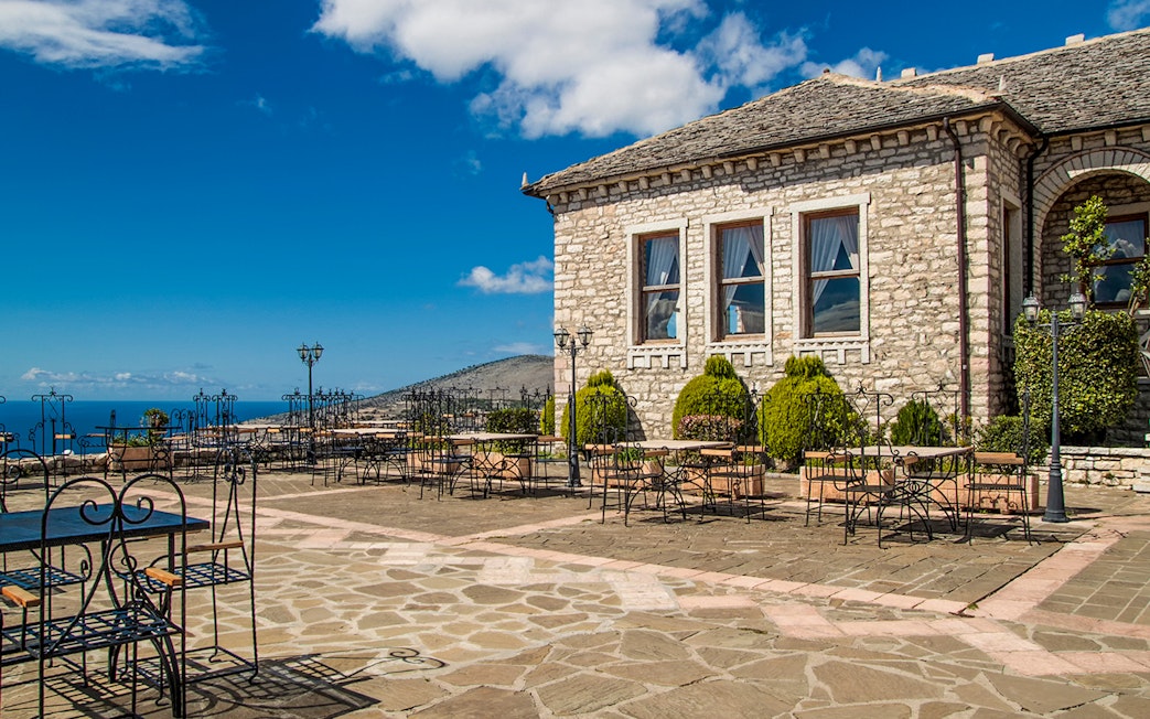 Lekursi Castle terrace with sea view and stone building in Saranda, Albania.