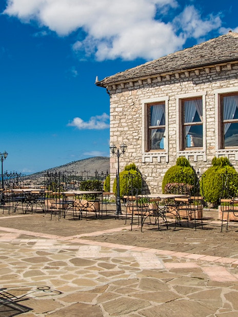 Lekursi Castle terrace with sea view and stone building in Saranda, Albania.