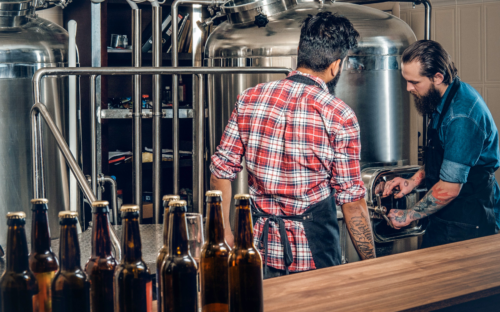 Two people inspecting distillery equipment on Mornington Peninsula tour.