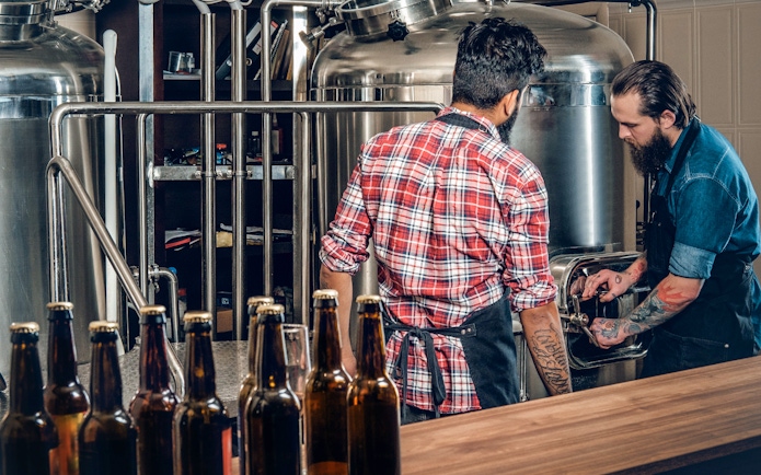 Two people inspecting distillery equipment on Mornington Peninsula tour.