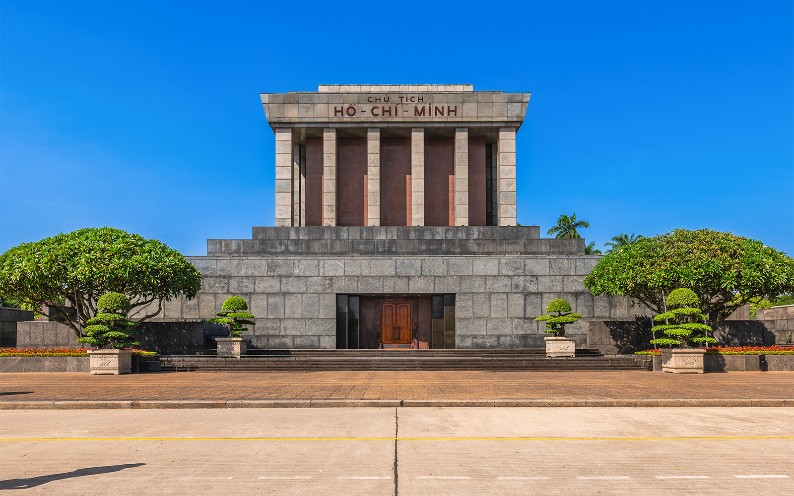 Hop-on Hop-off tour bus in front of the iconic Ho Chi Minh Mausoleum in Vietnam