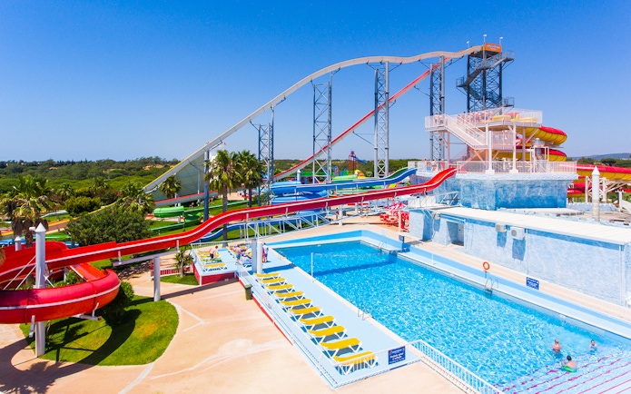 Water slides and pool at Aquashow Park, Portugal, with visitors enjoying the attractions.