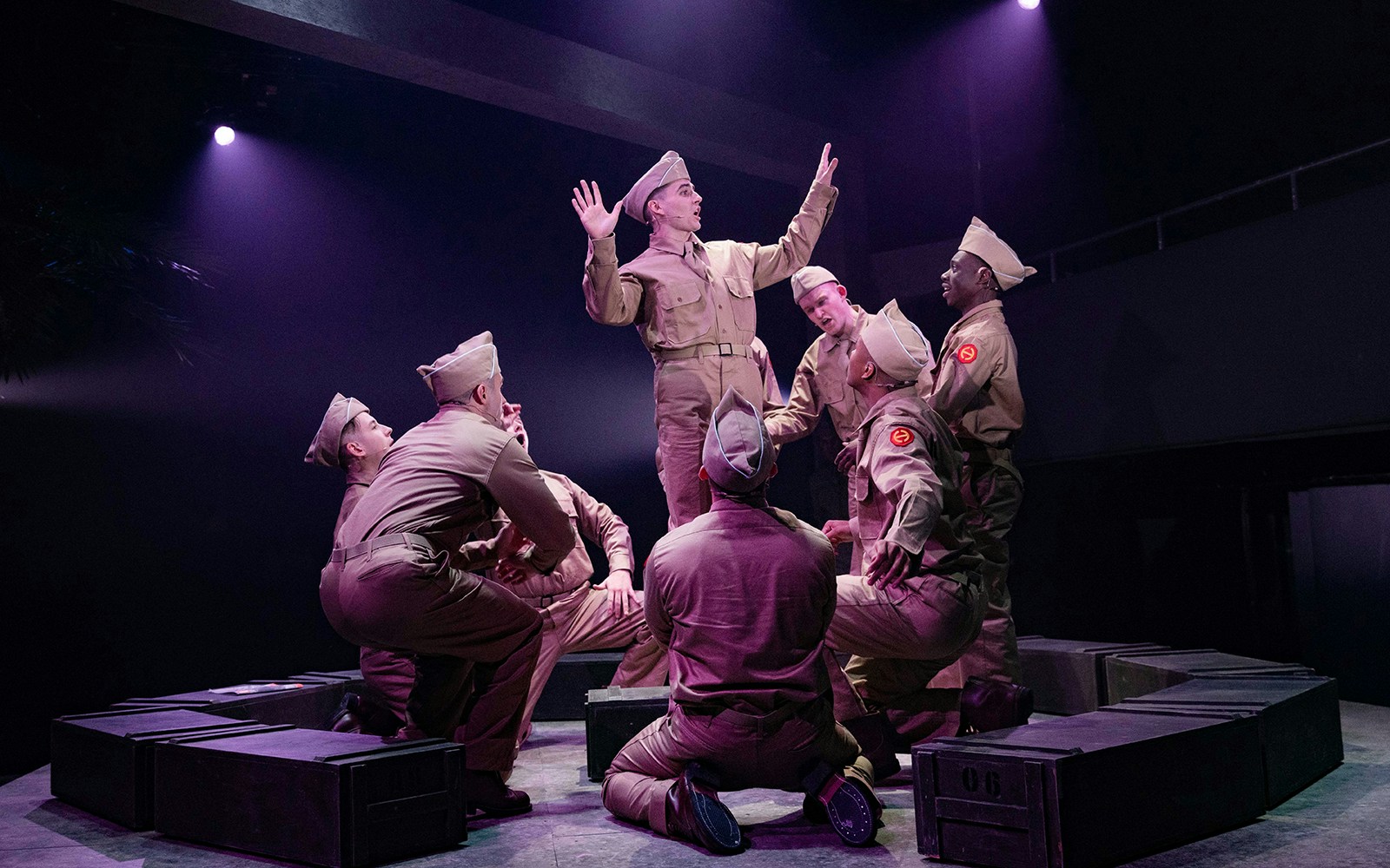 Soldiers performing a scene from "From Here To Eternity – The Musical" on stage.
