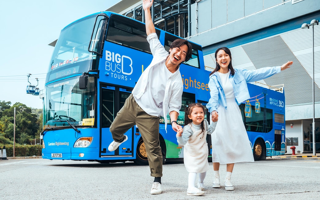 Family enjoying in front of BigBus on Lantau Island Hop-On Hop-Off Sightseeing Tour.