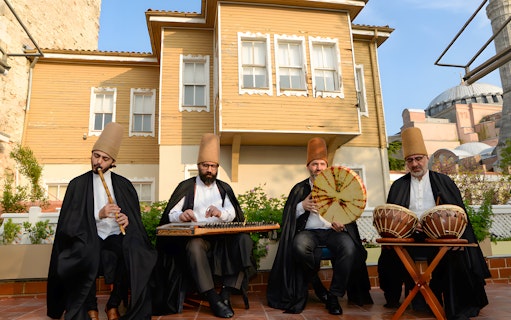 Musicians performing at an authentic Whirling Dervish show with Hagia Sophia in the background.