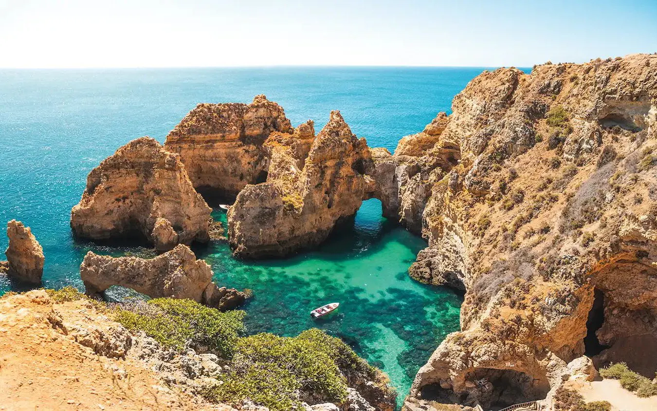 Boat cruising near Ponta da Piedade cliffs, Lagos, Portugal.