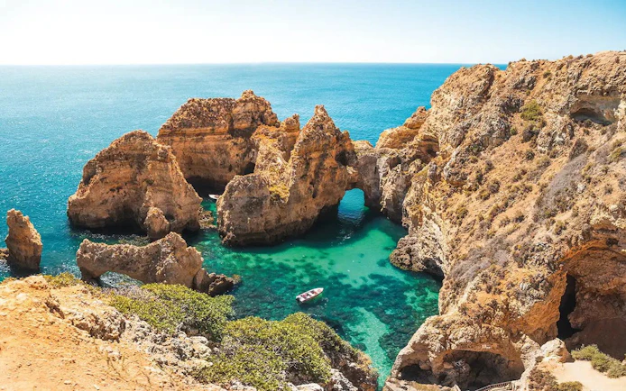 Boat cruising near Ponta da Piedade cliffs, Lagos, Portugal.