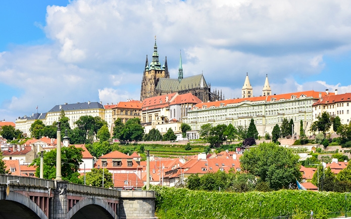 Prague Castle exterior with Gothic spires and surrounding historic buildings.