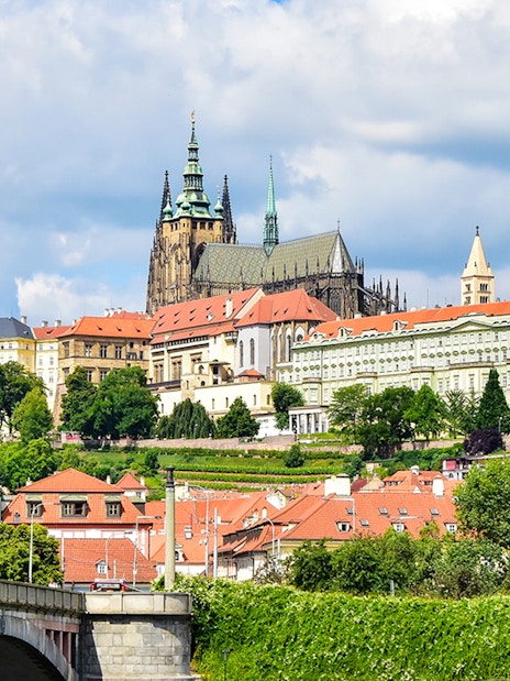 Prague Castle exterior with Gothic spires and surrounding historic buildings.