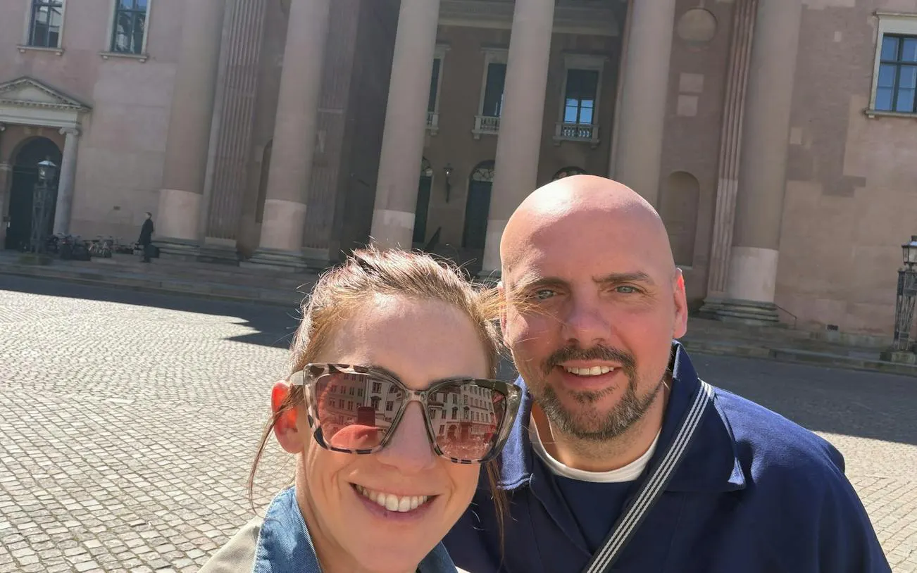 Copenhagen city exploration game participants in front of historic building.