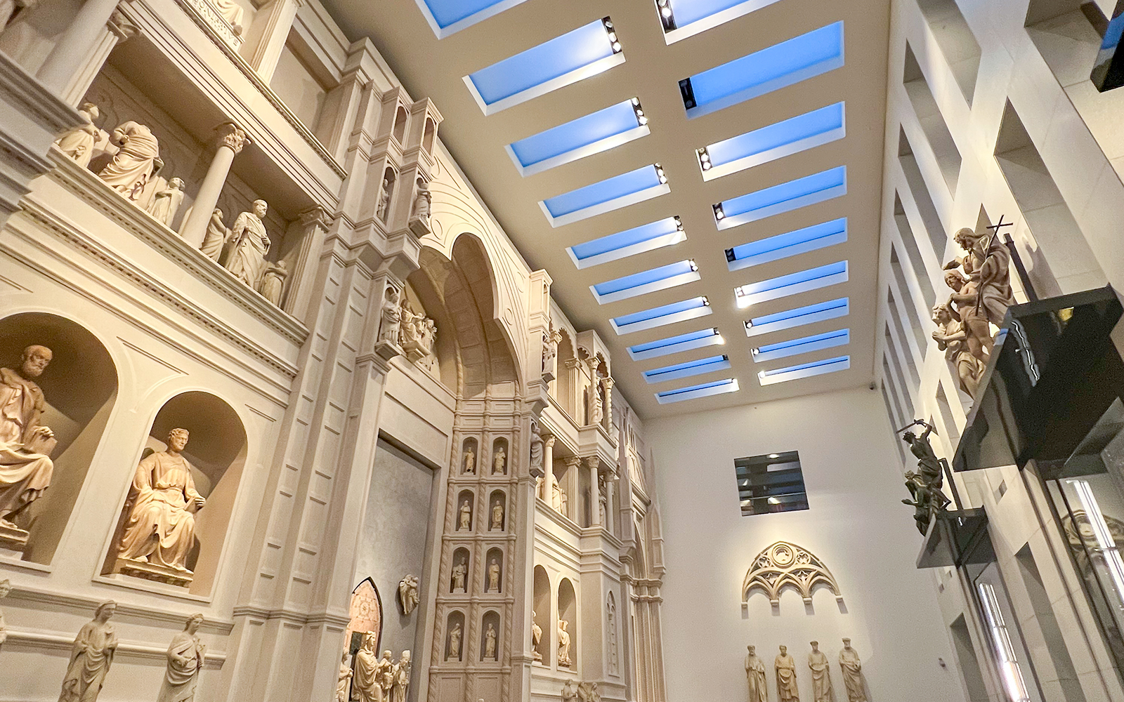 Interior view of Florence Duomo Museum with sculptures and architectural details.
