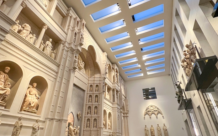 Interior view of Florence Duomo Museum with sculptures and architectural details.