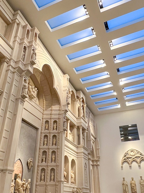 Interior view of Florence Duomo Museum with sculptures and architectural details.