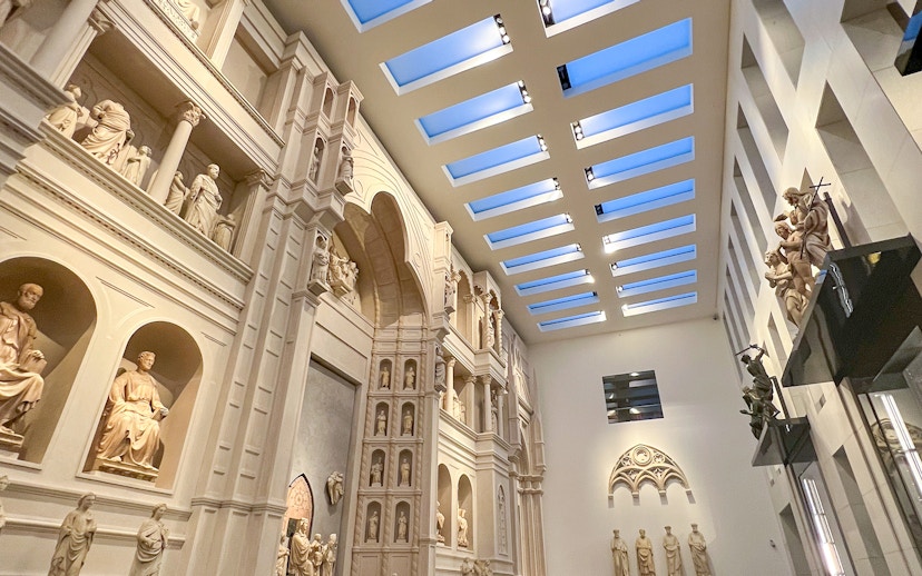 Interior view of Florence Duomo Museum with sculptures and architectural details.