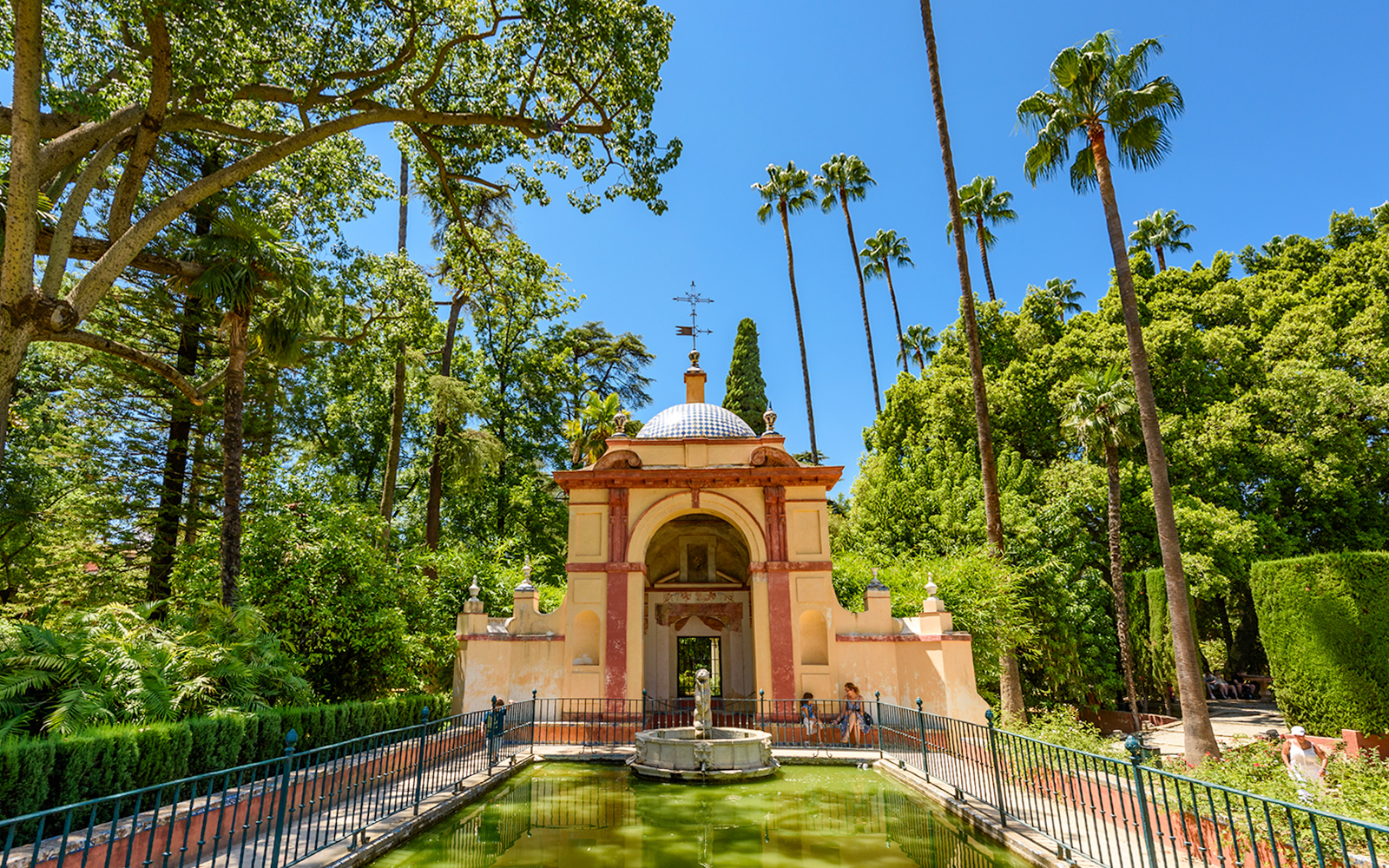 Patio de las Doncellas courtyard with reflecting pool at Seville Alcazar, Spain.