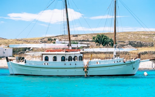 Guests swimming near a boat during a Corfu tour stop.