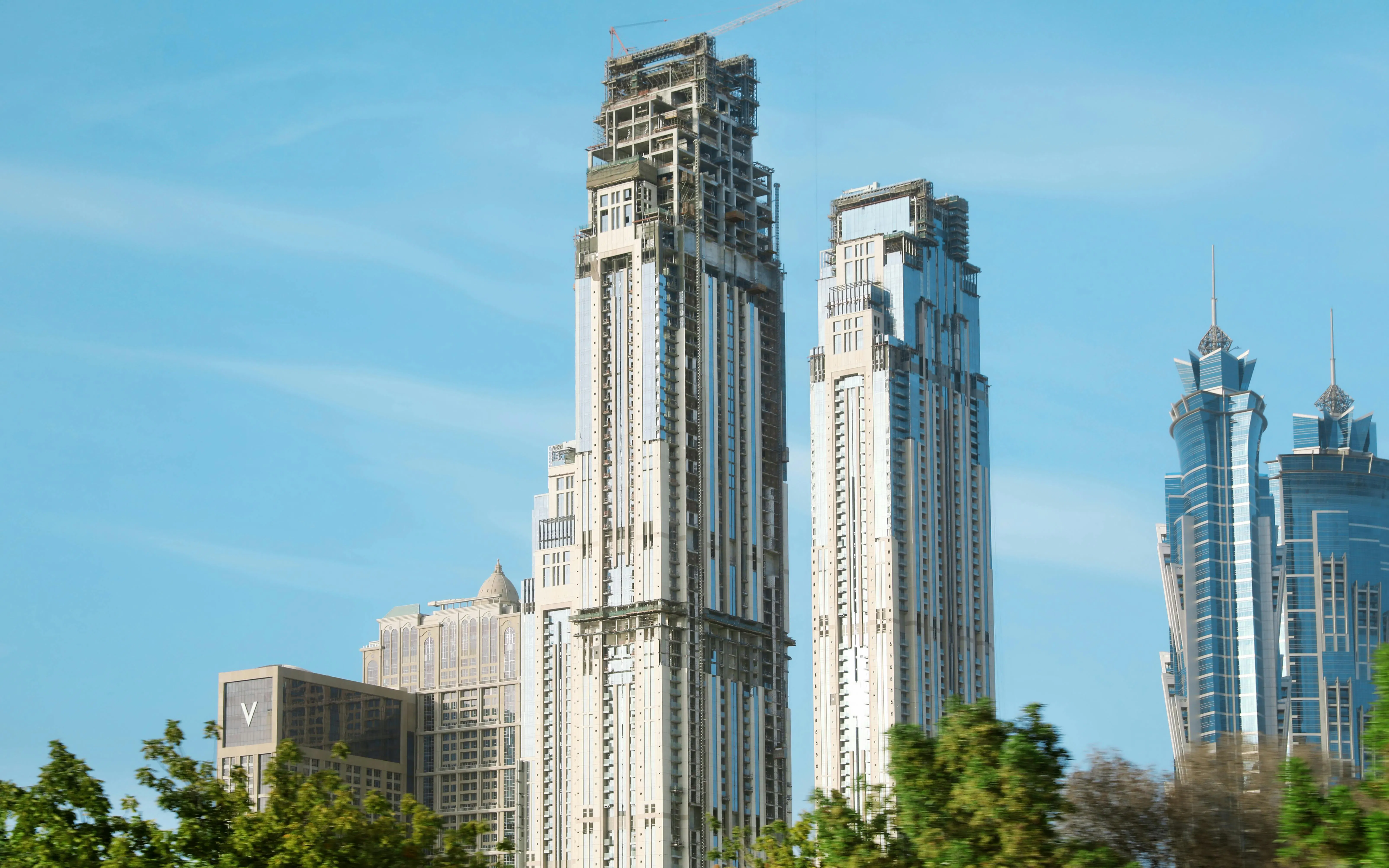 Al Habtoor City skyscrapers in Dubai with clear blue sky.