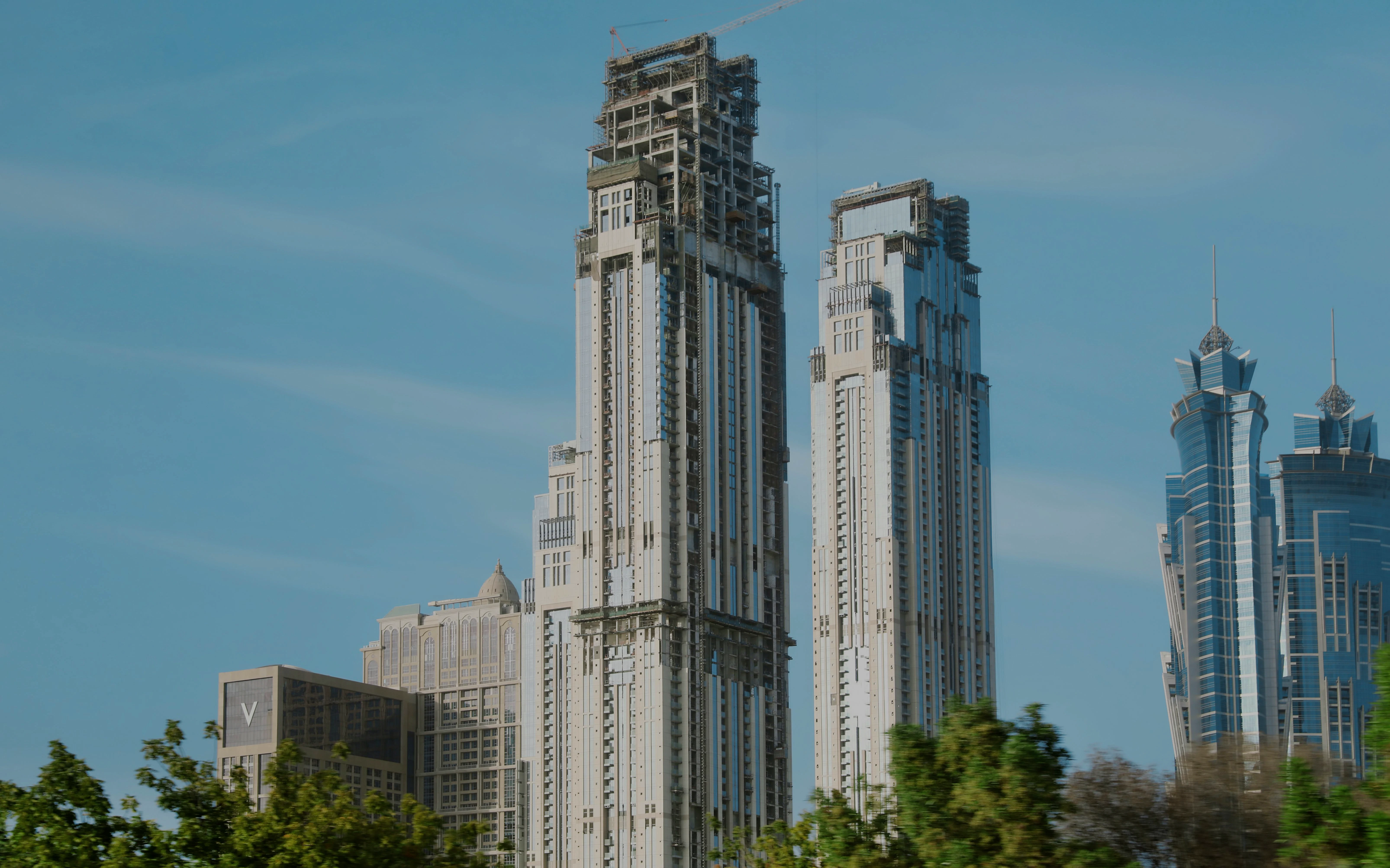 Al Habtoor City skyscrapers in Dubai with clear blue sky.