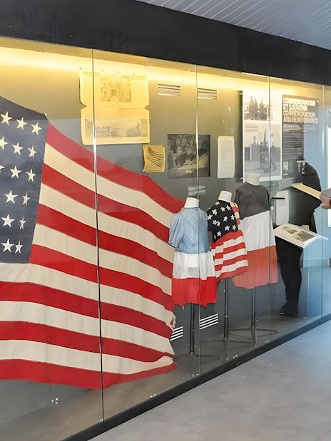 American flag display at Normandy museum exhibit, part of D-Day guided tour from Paris.