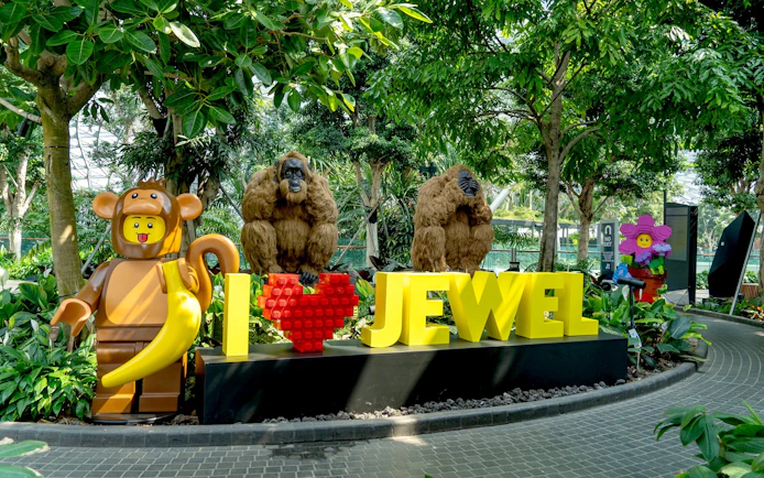 Jewel Canopy Park with LEGO sculptures and "I Love Jewel" sign amidst lush greenery.